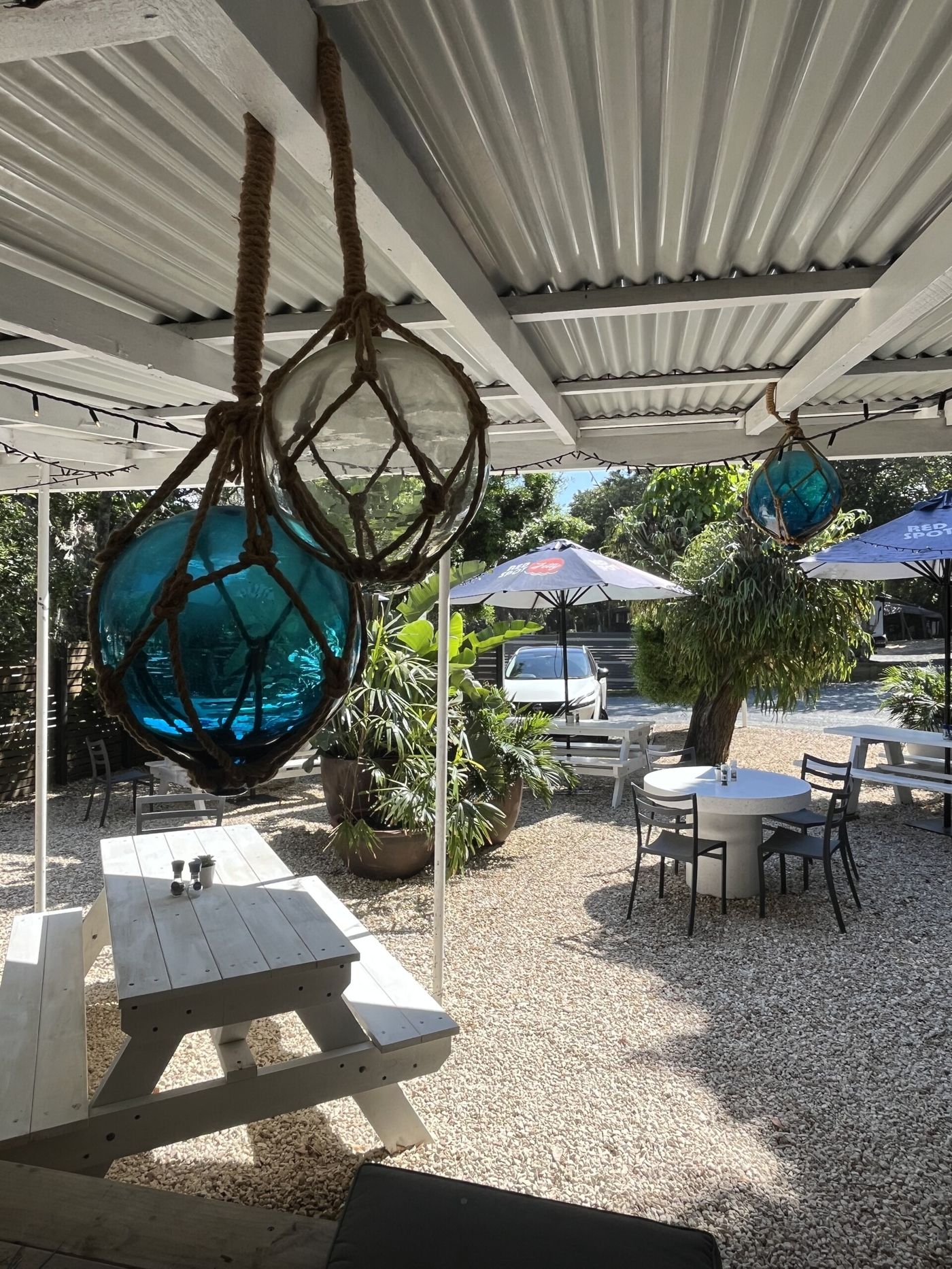 Glass fishing floats in rope nets hanging over the courtyard tables